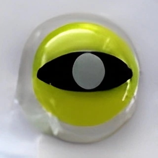 A round, clear object with a yellow sphere inside, featuring a black oval and a central white circle, resembling an eye, on a plain white background.