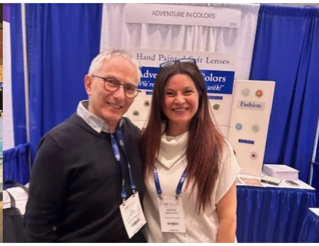 A man and woman posing for the camera at an event.