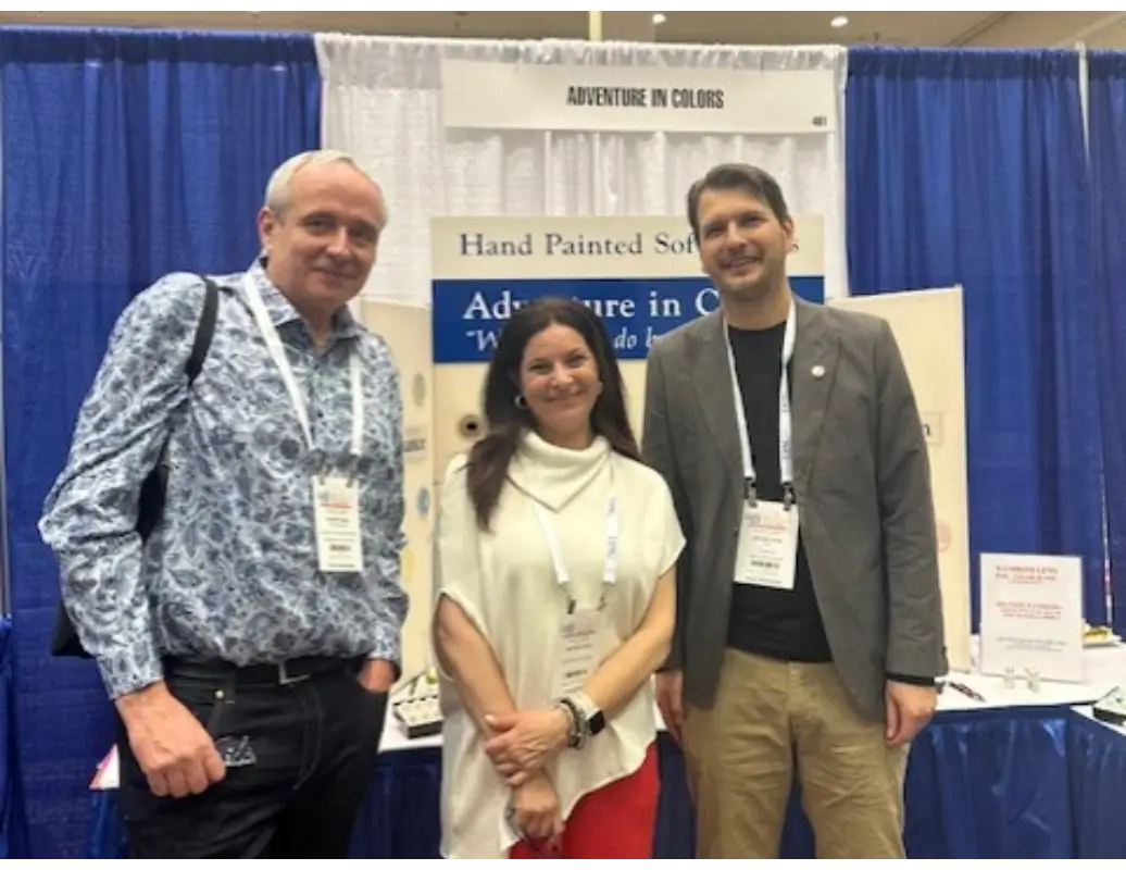 Three people standing in front of a banner.