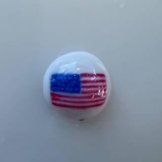 A button with an american flag on it.