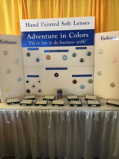 A table with many different colored contact lenses on it.